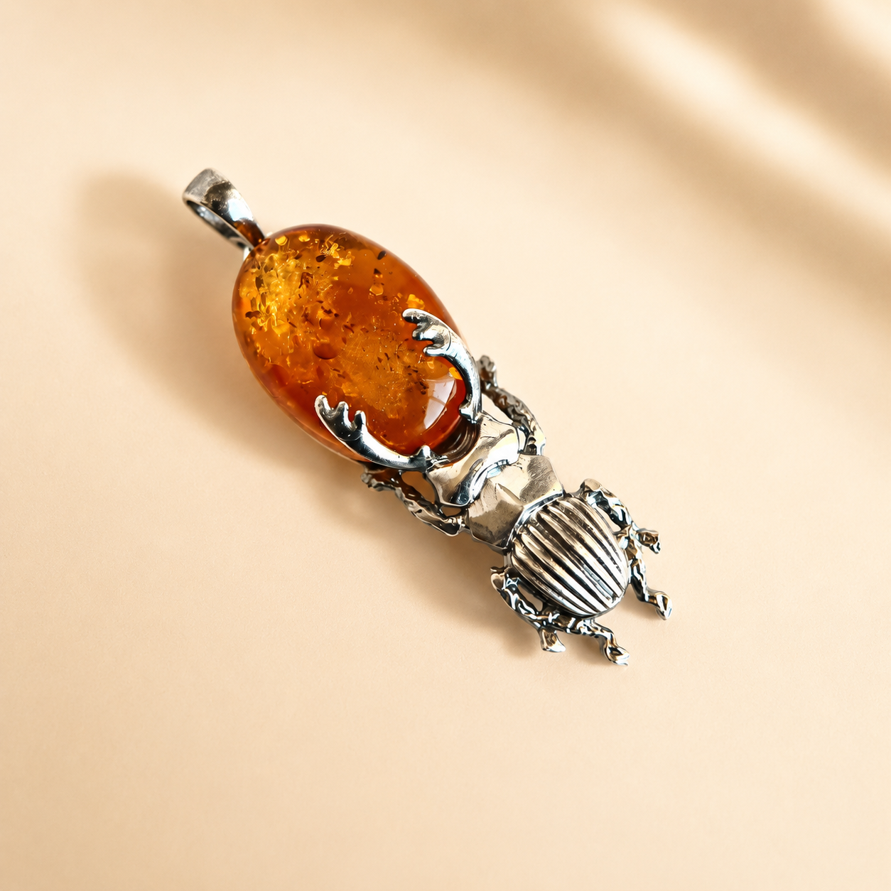 Spooky amber jewelry with spider, snake, bat, and mushroom designs