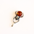 A silver amber spider pendant with four black eyes and a orange amber gemstone shown on a plain light gray background.