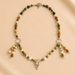 raven skull necklace on a beige background