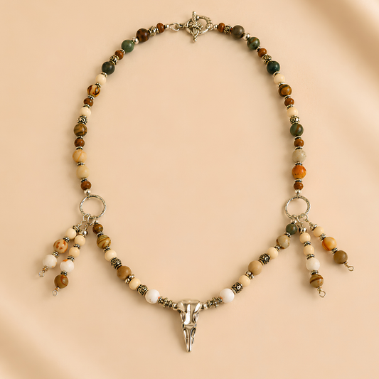 raven skull necklace on a beige background