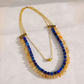 Natural lapis, citrine, and olive jade statement necklace with gold plated brass chain on a warm cream background.