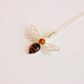 amber bee necklace on white background