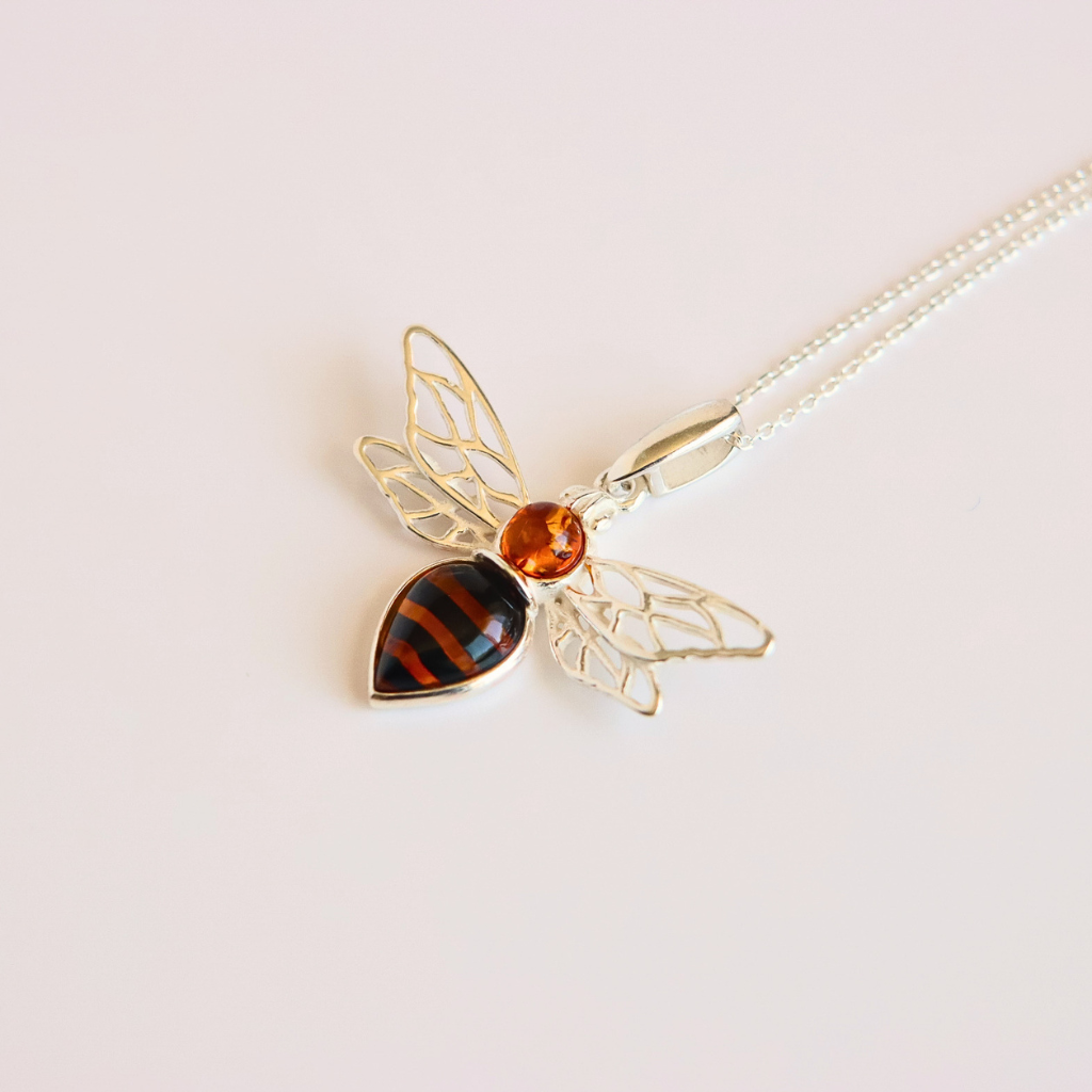 amber bee necklace on white background