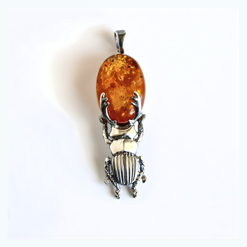 silver amber beetle pendant on a white background