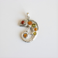 Silver chameleon amber pendant with colored stones on a white background