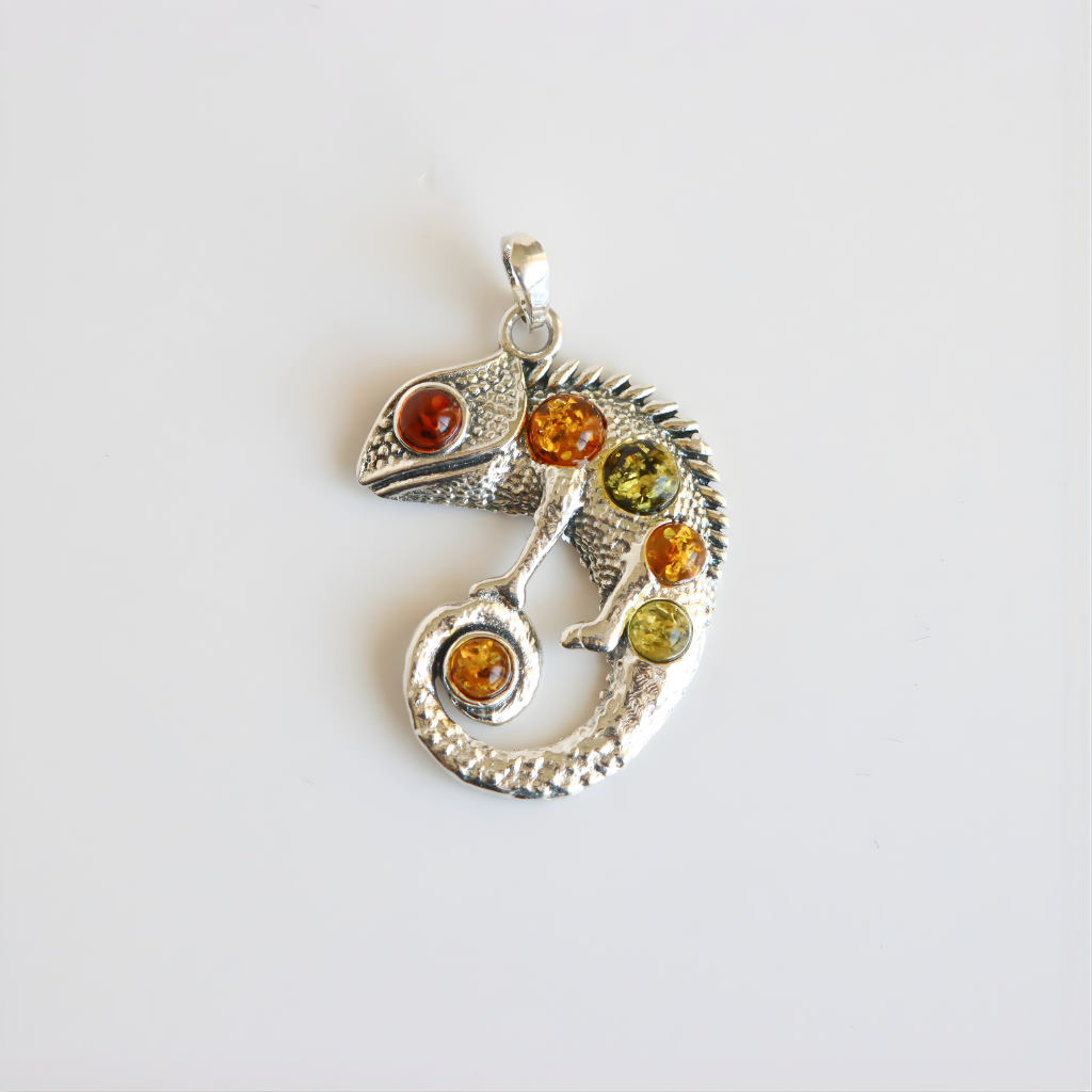 Silver chameleon amber pendant with colored stones on a white background
