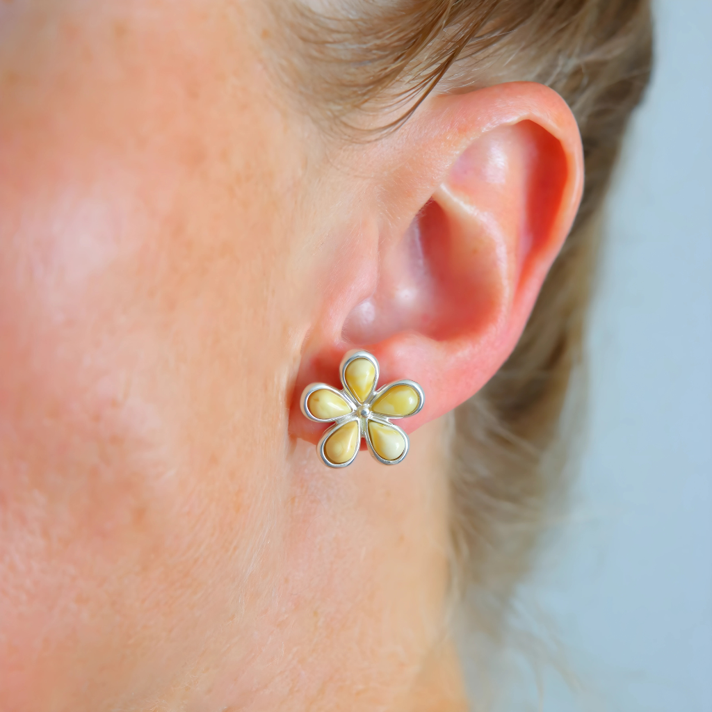 daisy stud earrings on ear