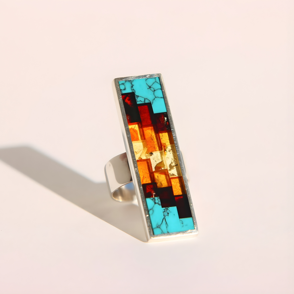 Colorful mosaic amber ring with a silver band on a light background