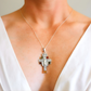 amber cross necklace on a mannequin with a white background