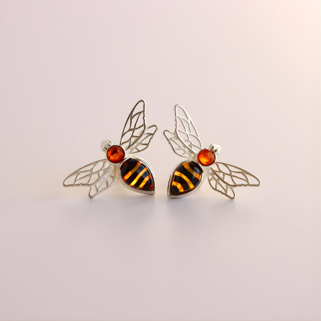 Bee-shaped amber earrings with amber accents on a light background