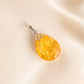 Amber pendant on a beige background