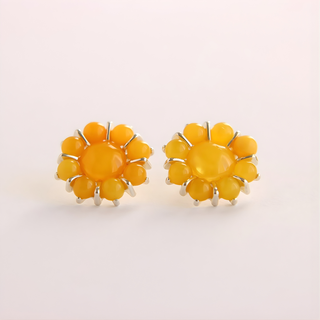 Yellow flower earrings on a light beige background