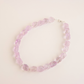 amethyst beaded choker necklace on a light pink background