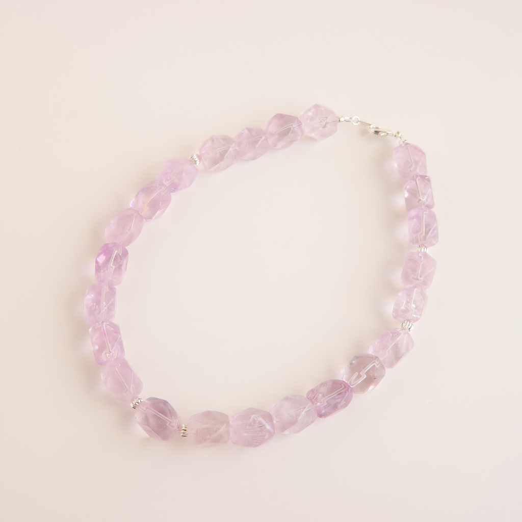 amethyst beaded choker necklace on a light pink background