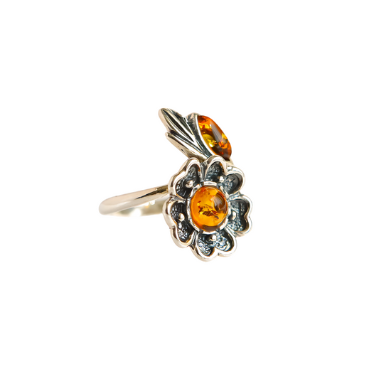 Natural Baltic cognac amber adjustable flower ring with sterling silver band.