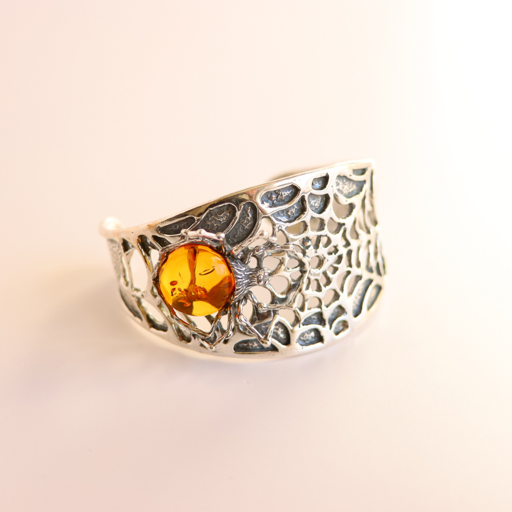 amber bracelet with a central cognac amber stone and textured silver design on a light background
