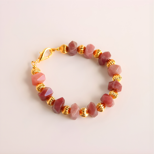 Beaded bracelet with pink Botswana agate stones and gold accents on a light background