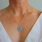 Necklace from flower jewelry set worn by a person in a white top