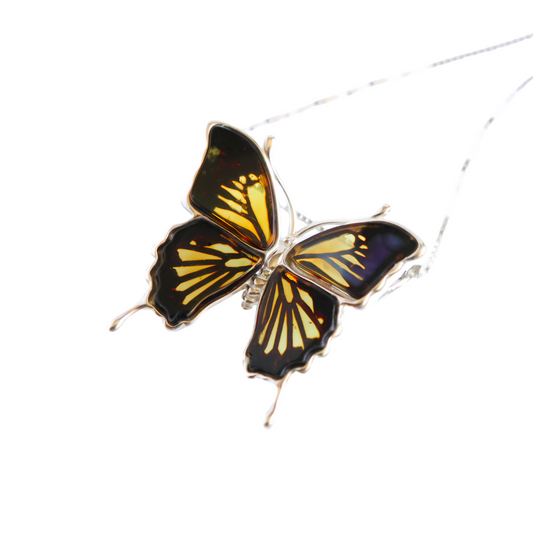 Baltic amber butterfly necklace in sterling silver with lemon and black design.