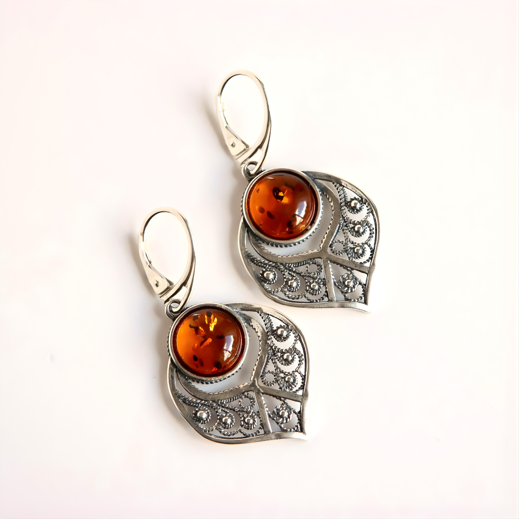 Pair of sterling silver earrings with amber stones on a white background