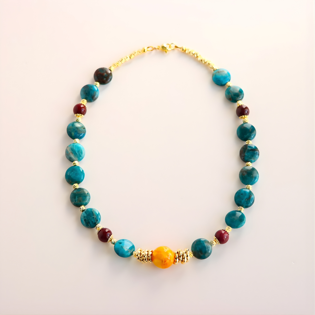 beaaded Necklace with blue, red, and gold beads on a light background