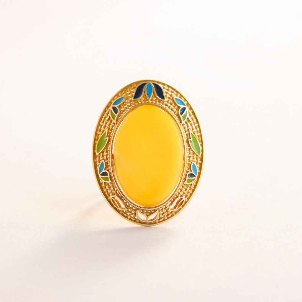 Decorative oval butterscotch amber ring with a yellow center and gold rim on a white background