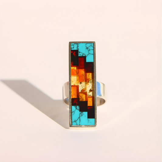 Colorful mosaic amber ring on a light background