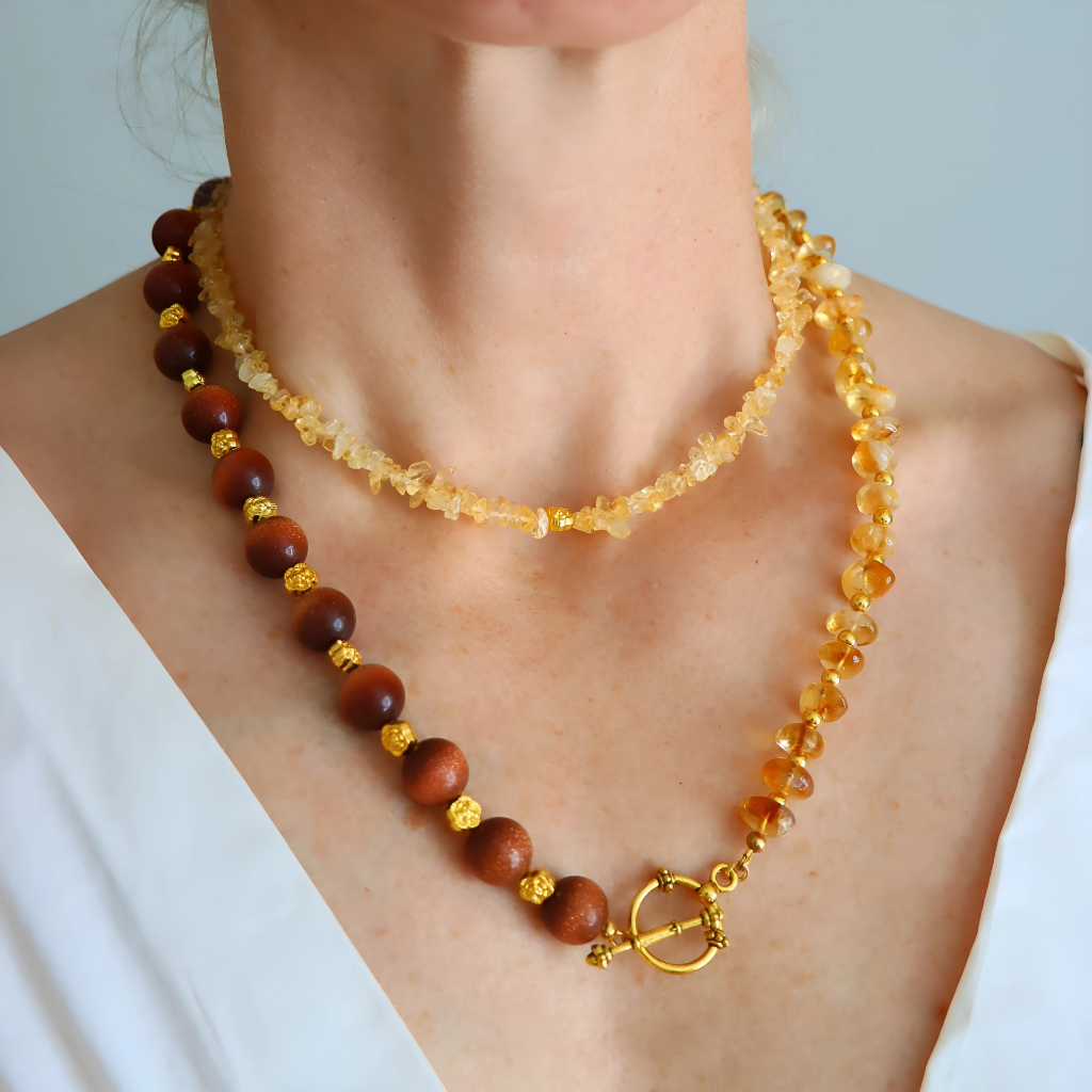 Handmade layered necklace with goldstone and citrine, gold plated beads, gold flower accents, choker and long strand design by Alexis Cintron.