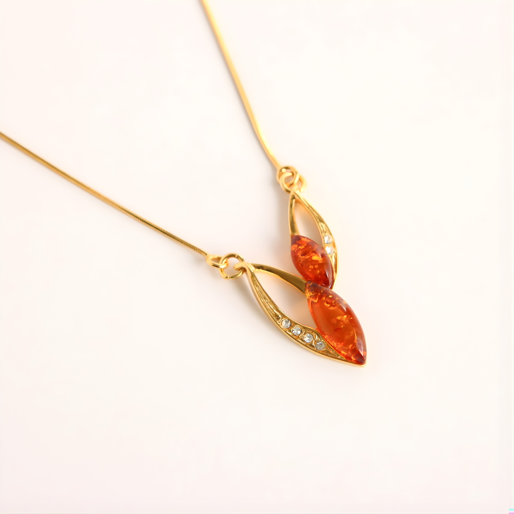 Gold amber necklace with amber pendant on a white background