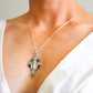 amber cross necklace on a mannequin with a white background