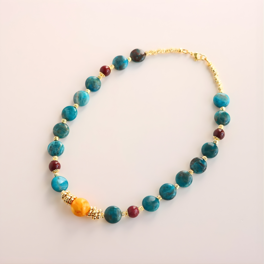 beaded Necklace with blue, red, and gold beads on a light background