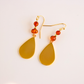 gold drop earrings with amber gemstones on white background