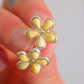 daisy amber stud earring close up on blurred background