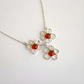 Amber Floral necklace with orange centers on a white background