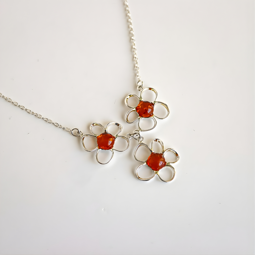 Amber Floral necklace with orange centers on a white background