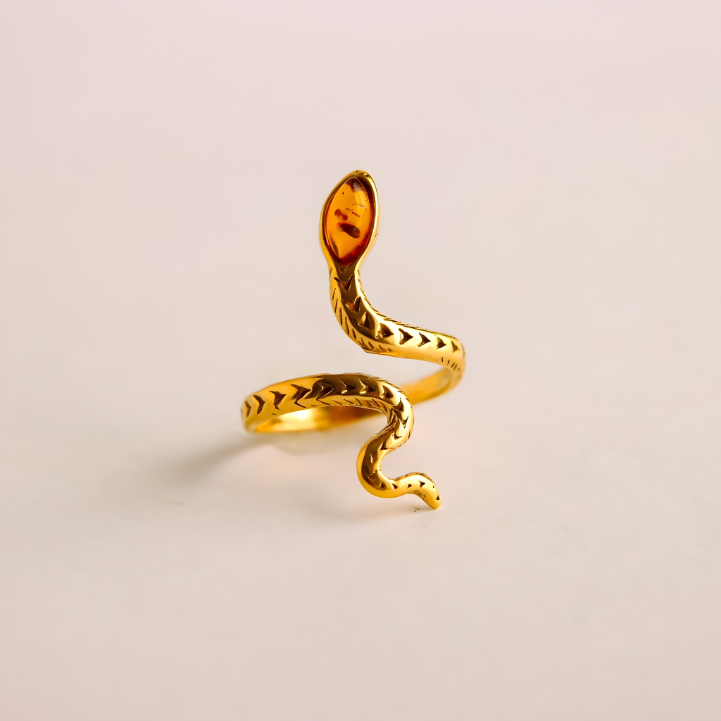 Gold snake ring on a beige background