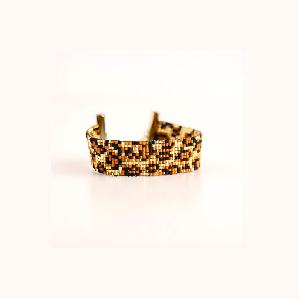 Beaded bracelet with a leopard pattern on a white background
