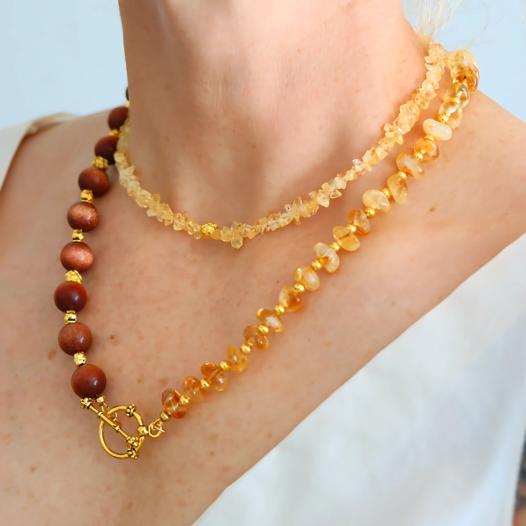 Handmade layered necklace with goldstone and citrine, gold plated beads, gold flower accents, choker and long strand design by Alexis Cintron.