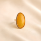Amber Ring with a yellow stone on a beige background