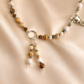 raven skull Necklace with beaded chain and pendant on a beige background
