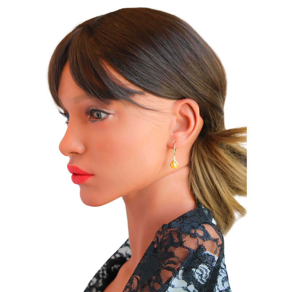 Gold Amber Earrings Baltic amber claw dangle earrings in 14k gold-plated sterling silver on model.