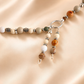 Beaded raven skull necklace with silver clasps on a beige background