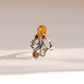An ornate silver amber octopus ring featuring a large oval amber top stone and three smaller round amber accent stones, photographed on a clean, light beige background.