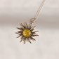 A silver lemon Baltic amber sun pendant necklace with a yellow amber center, displayed on a clean white background with soft shadows.