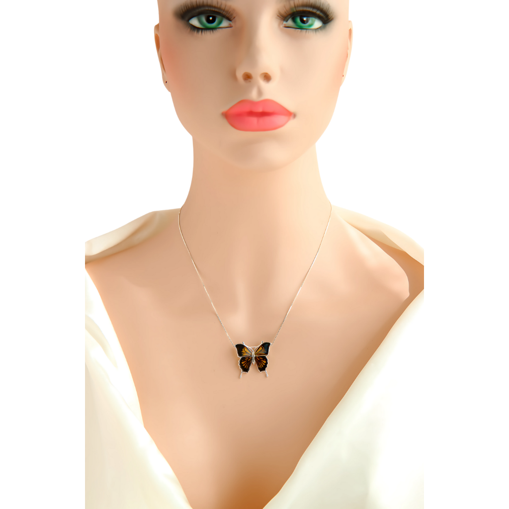 Baltic amber butterfly necklace in sterling silver on model's neck.