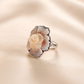 cameo shell flower ring on a soft pink background