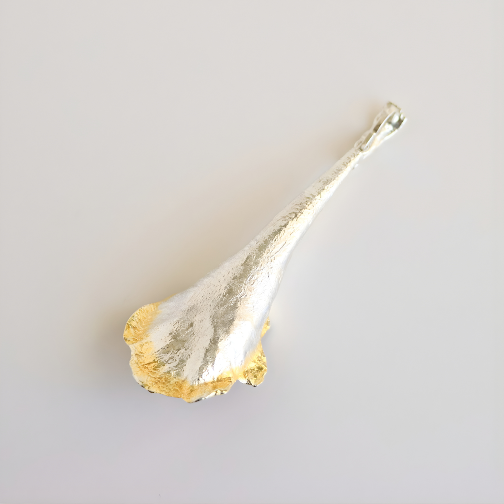 Decorative amber necklace with gold and silver finish on a light gray background