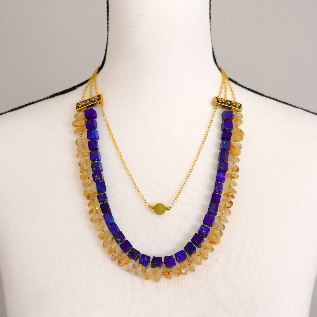 Lapis, citrine, and olive jade statement necklace displayed on a mannequin to show length and fit.