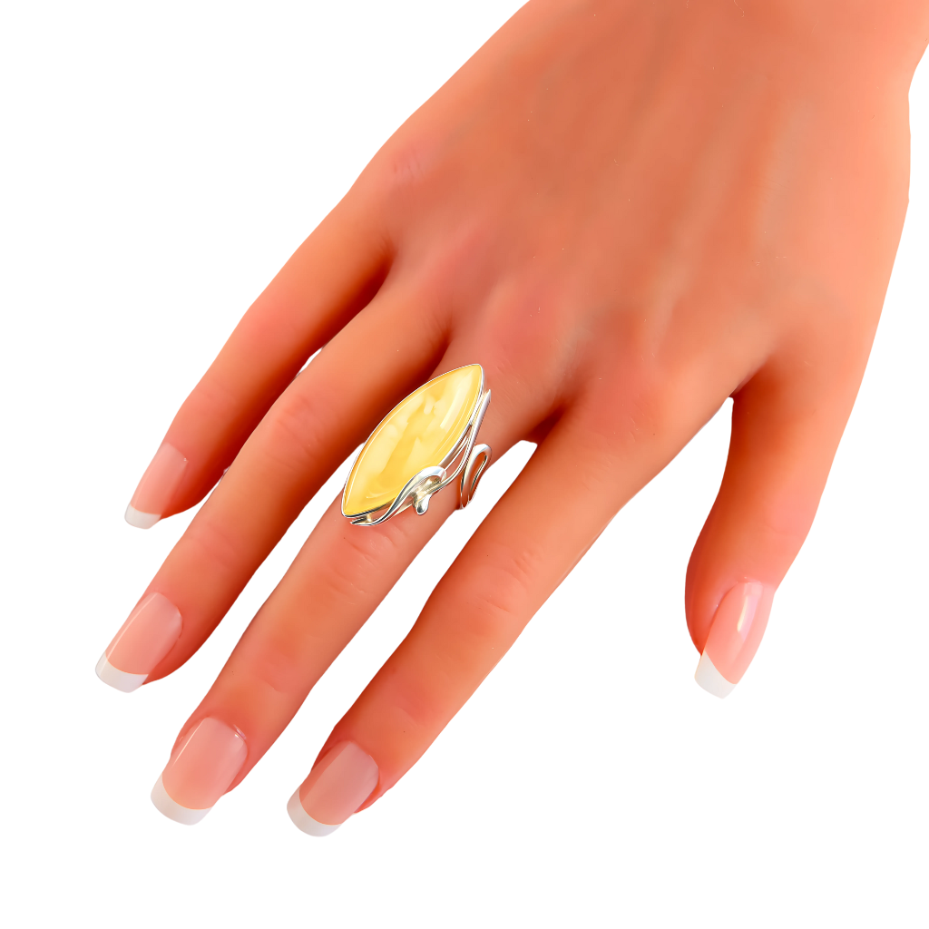 Natural Baltic lemon amber marquise cut sterling silver statement ring on hand.