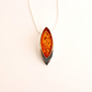 Amber pendant on a white background- sterling silver necklace